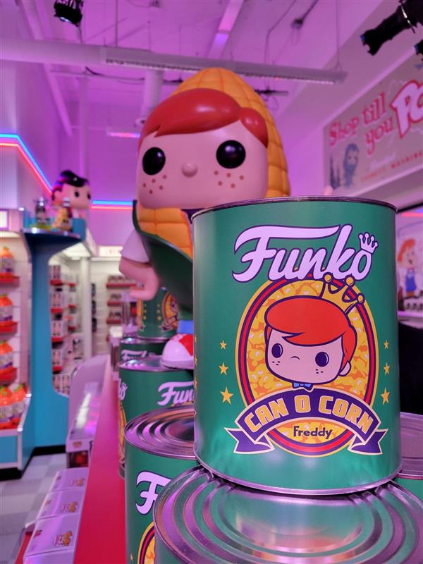 Funmart! Inside the store, you’ll find Funmart, which is decorated like a retro grocery store. This photo features a statue of Freddy Funko wrapped in an ear of corn and a large “Funko Can o Corn Freddy,” which is shaped like a can.